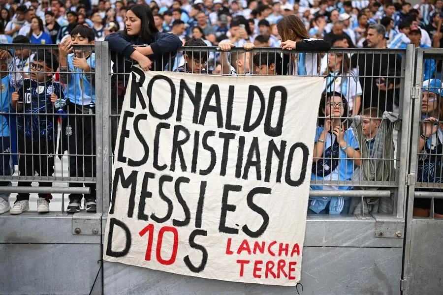 Soccer Football - International Friendly - Argentina v Benin - Estadio Monumental, Buenos Aires, Argentina - October 6, 2026 Argentina fans in the stands display a flag that reads, \\\"Ronaldo is Cristiano (Christian), but (Lionel) Messi is God.\\\" REUTERS/Rodrigo Valle