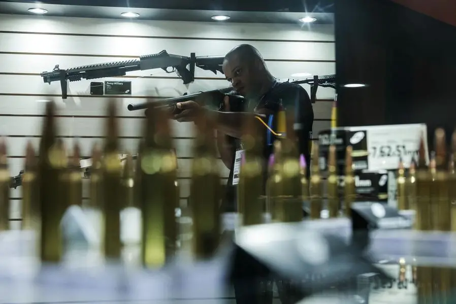 A person holds a weapon during LAAD, the biggest military industry expo in Latin America, in Rio de Janeiro, Brazil April 1, 2025. REUTERS/Ricardo Moraes