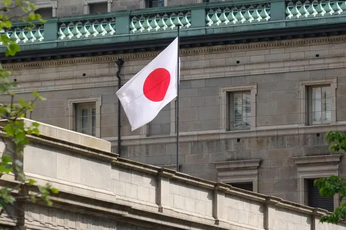 Japan's national flag flutters at the Bank of Japan headquarters in central Tokyo on April 26, 2024. (Photo by Kazuhiro NOGI / AFP)