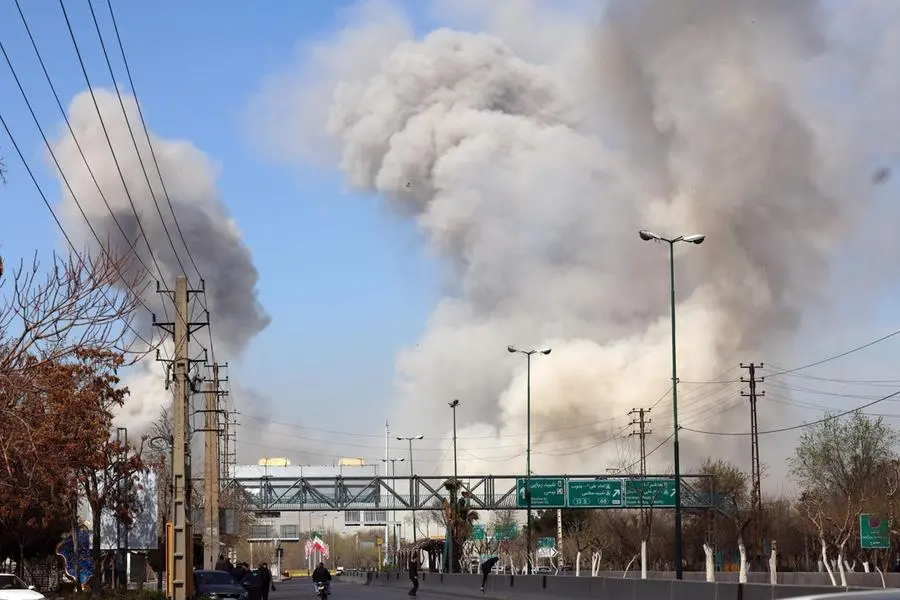 epa12796261 People run for safety as smoke rises after an airstrike in central Tehran, Iran, 05 March 2026. A joint Israeli and US military operation continues to target multiple locations across Iran since the early hours of 28 February 2026. EPA/ABEDIN TAHERKENAREH