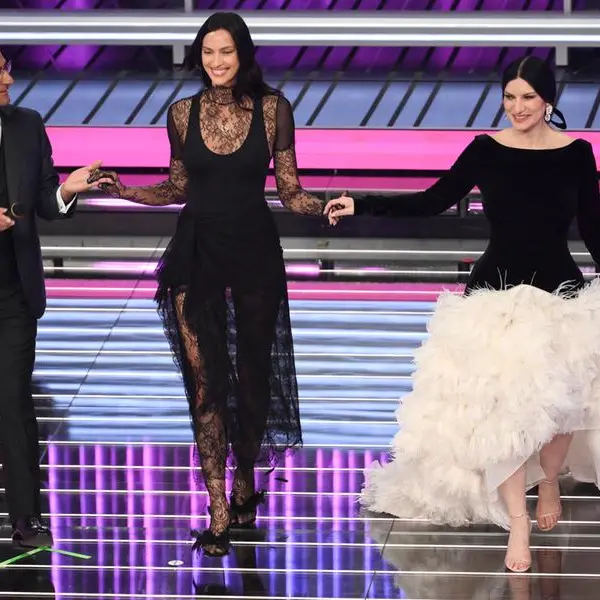 (L-R) Sanremo Festival host and artistic director Carlo Conti with Russian model Irina Shayk and Italian singers Laura Pausini on stage at the Ariston theatre during the 76th edition of the Sanremo Italian Song Festival, in Sanremo, Italy, 26 February 2026. The music festival will run from 24 to 28 February 2026. ANSA/ETTORE FERRARI