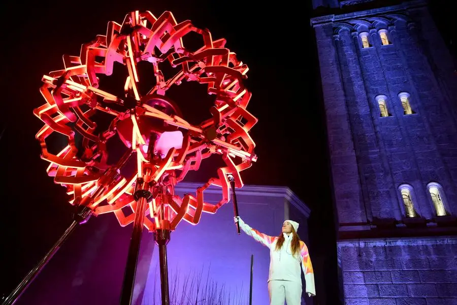 Milano Cortina 2026 Olympics - Opening Ceremony - Cortina d'Ampezzo, Cortina d'Ampezzo, Italy - February 6, 2026 General view as Sofia Goggia of Italy holds the Olympic torch after lighting the Olympic cauldron during the opening ceremony Pool via REUTERS/Stefano Rellandini