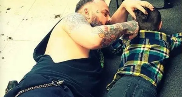 Il gesto di un parrucchiere gentile che taglia i capelli al bambino autistico