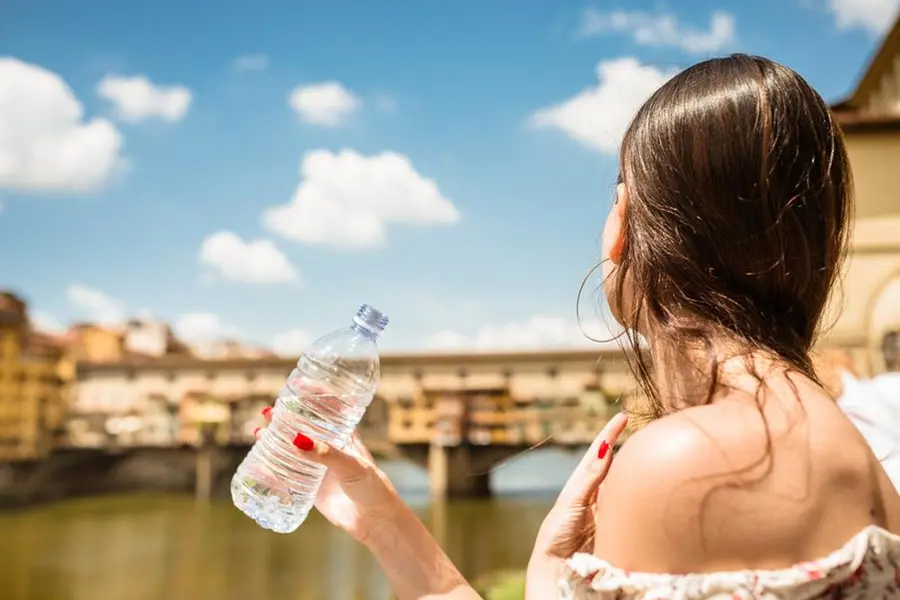 Tourist in drinking water at ponte vecchio - florence