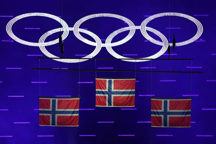 Milano Cortina 2026 Olympics - Cross-Country Skiing - Men's 50km Mass Start Classic Victory Ceremony - Verona Olympic Arena, Verona, Italy - February 22, 2026. The national flags of gold medallist Johannes Hosflot Klaebo of Norway, silver medallists Martin Lowstrom Nyenget of Norway and bronze medallist Emil Iversen of Norway are raised during the Men's 50km Mass Start Classic Victory Ceremony. REUTERS/Claudia Greco