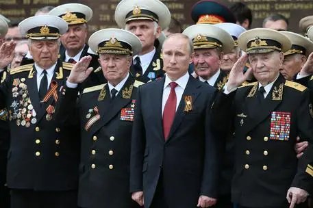 epa04198259 Russian President Vladimir Putin (C) stands among veterans as he attends a parade marking the 69th anniversary of the victory over the Nazi Germany in the WWII in Sevastopol, Crimea, 09 May 2014. Russian President Vladimir Putin arrived in Crimea, the peninsula annexed by Russia from Ukraine in March, to take part in celebrations marking the Soviet victory over Nazi Germany in World War II. EPA/SERGEI ILNITSKY