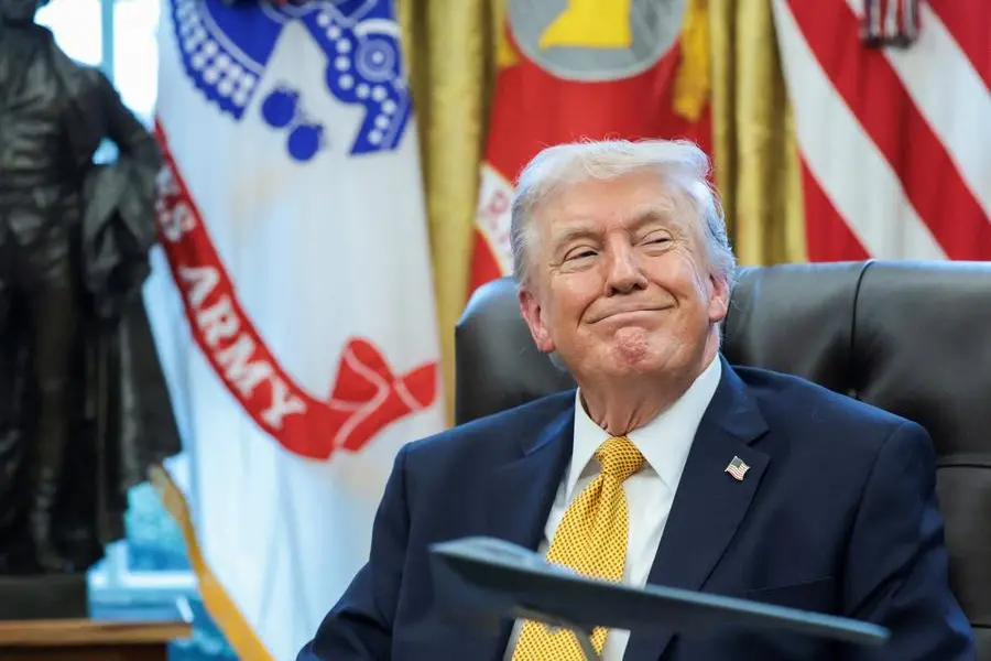 U.S. President Donald Trump reacts as he sits behind a model of a B\\u20112 bomber commemorating \"Operation Midnight Hammer\" during an event to sign an executive order creating an anti\\u2011fraud task force headed by U.S. Vice President JD Vance in the Oval Office at the White House in Washington, D.C., U.S., March 16, 2026. REUTERS/Jonathan Ernst , REUTERS