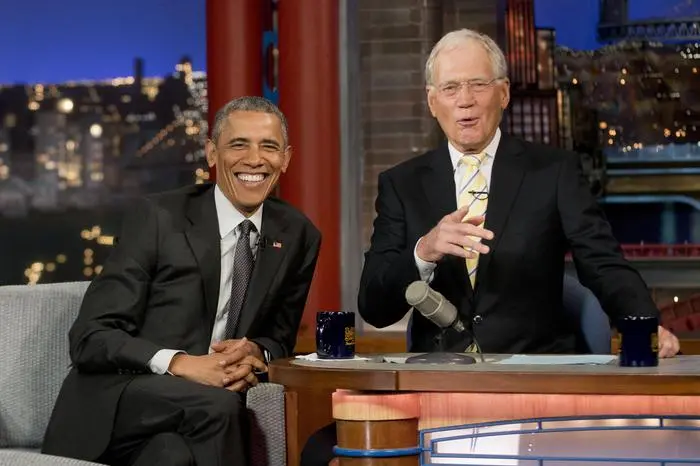 President Barack Obama with host David Letterman talk during a break at a taping of CBS' The Late Show with David Letterman at the Ed Sullivan Theater in New York, Monday, May 4, 2015. Obama traveled to New York to announced the creation of an independent nonprofit organization that is a spinoff his \\\"My Brother's Keeper\\\" program, to tape a segment on Letterman's show and to do fundraising for the Democratic party. (ANSA/AP Photo/Pablo Martinez Monsivais)
