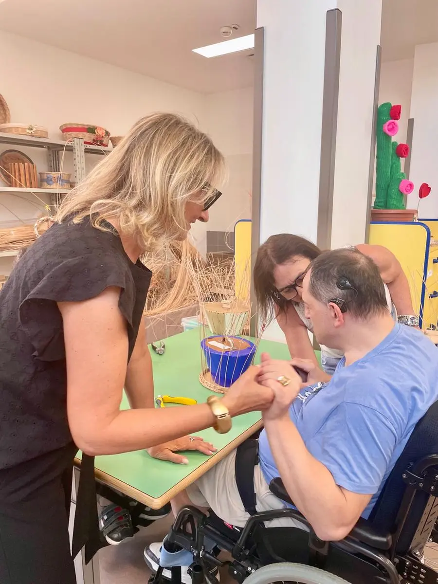 Doctor Nicoletta Marconi with Luigi in the basket-making laboratory.
