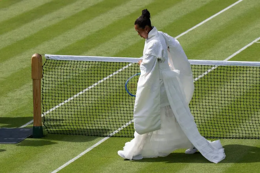 Jun 29, 2026; London, United Kingdom; Naomi Osaka of Japan on the court in her Japanese inspired ceremonial dress designed with designer Hana Yagi for her match against Elsa Jacquemot of France on day one at All England Lawn Tennis and Croquet Club. Mandatory Credit: Susan Mullane-Imagn Images