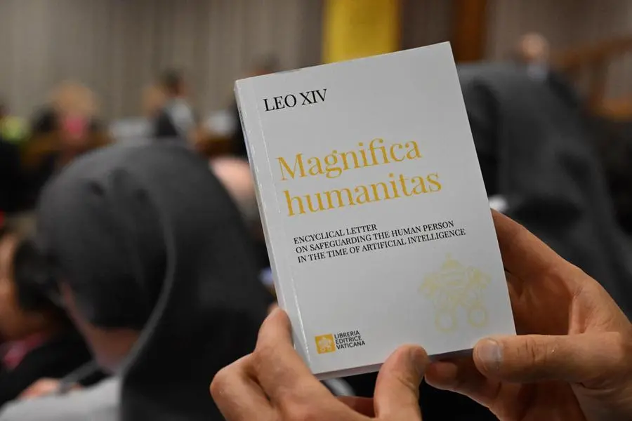 A person holds in his hands the Encyclical Letter \\\"Magnifica Humanitas\\\" focused on the rise of artificial intelligence, on the day of its promulgation by Pope Leo XIV, in The Vatican on May 25, 2026. ANSA/MAURIZIO BRAMBATTI