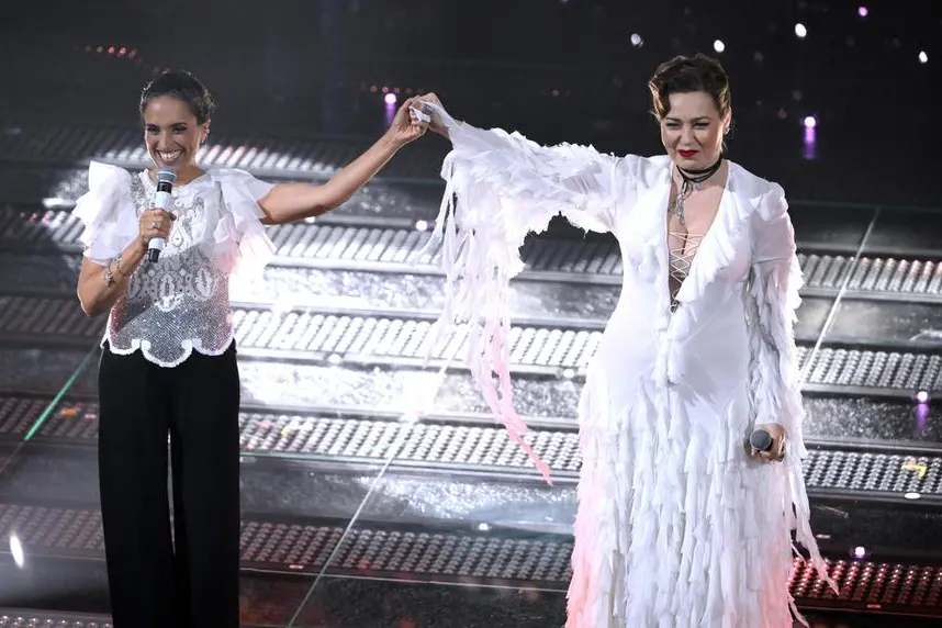 Israeli singer Noa (L) and Palestinian singer Mira Awad (R) perform on stage at the Ariston theatre during the 75th edition of the Sanremo Italian Song Festival, in Sanremo, Italy, 11