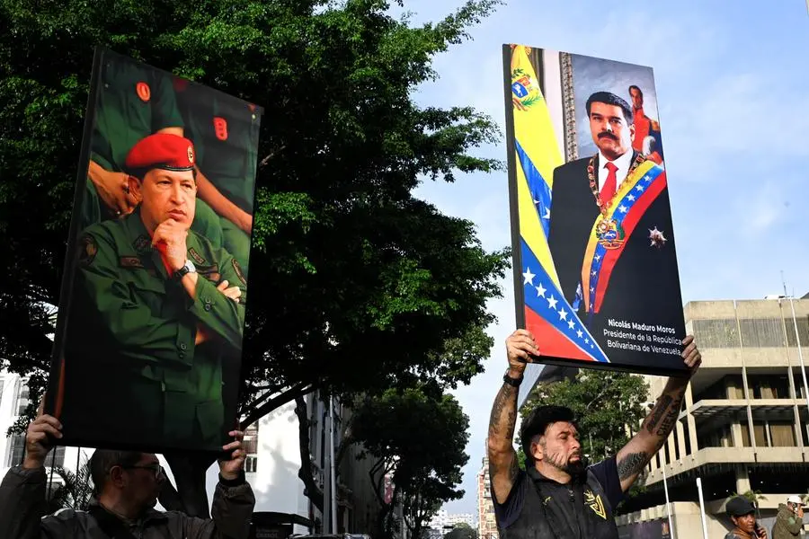 Supporters of President Nicolas Maduro and his predecessor Hugo Chavez on the square in Caracas after US raids