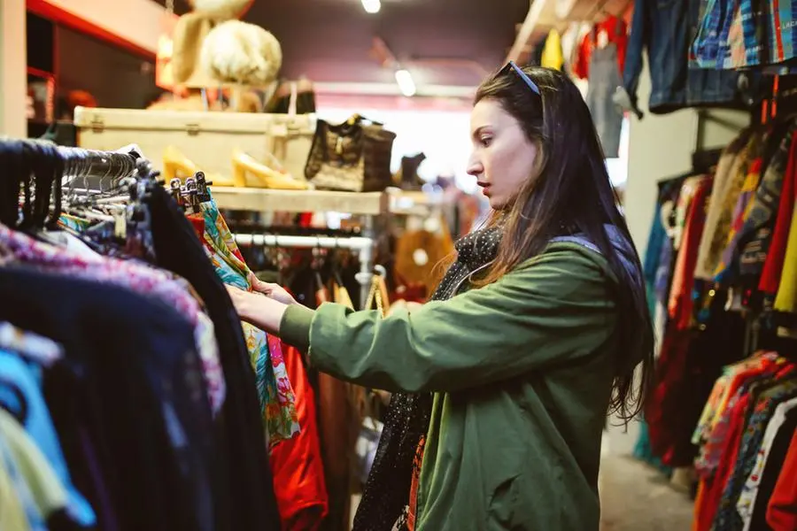 A girl intent on choosing a used item to buy.