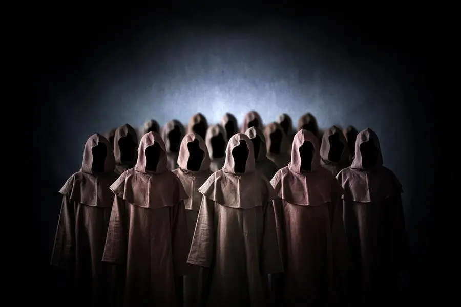 Group of scary figures in hooded cloaks , Getty Images/iStockphoto