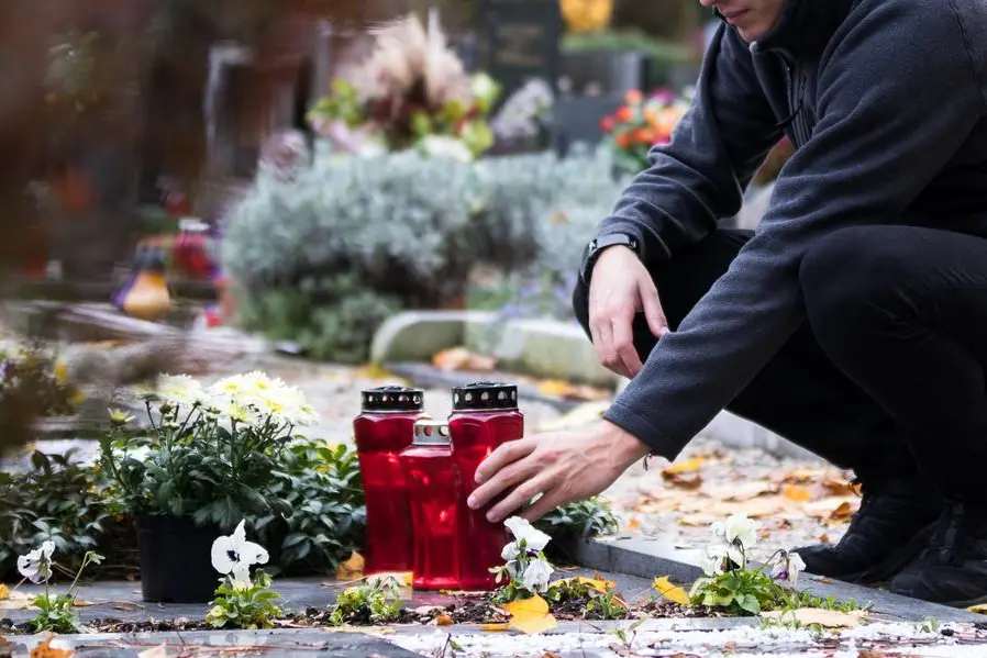 grieving soldier in the cemetery visiting his mother after a long time. , istock