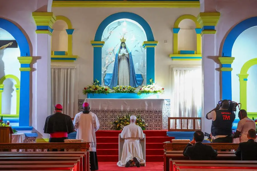The Pope in prayer in the Church of Our Lady of Muxima.