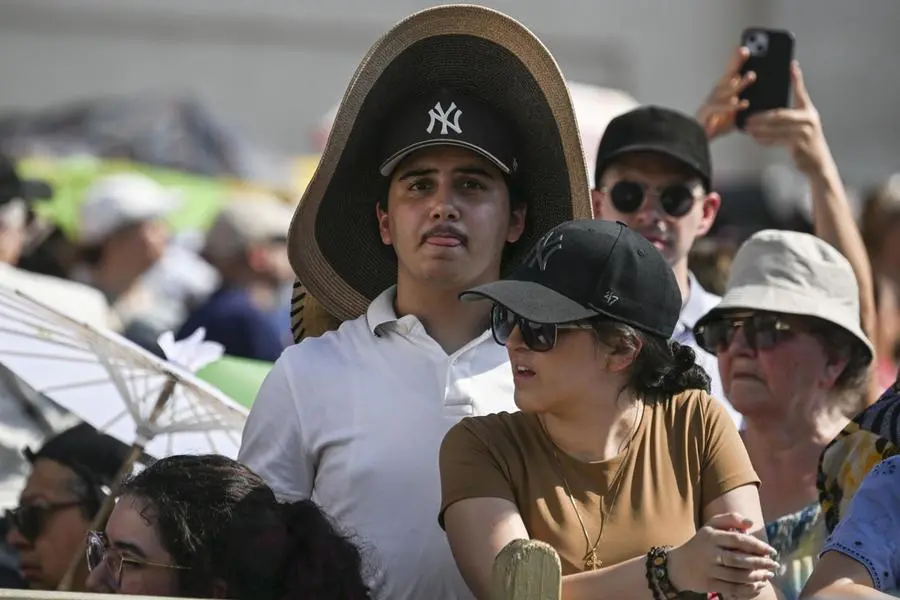 Å faithful takes shelter from heat during the weekly General Audience leaded by Pope Leo (not pictured) in Saint Peter's Square, Vatican City, 24 June 2026. ANSA/RICCARDO ANTIMIANI