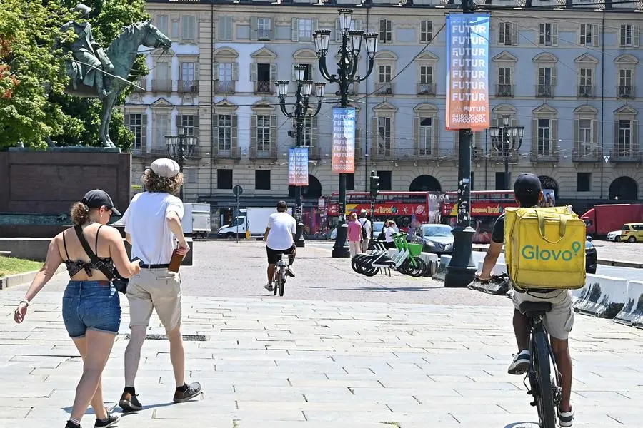 A rider at work in Turin below during the latest heat wave