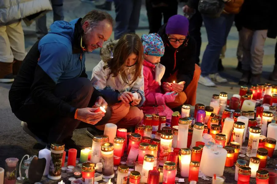 People light candles outside the \"The Constellations\" bar, after a fire and explosion during a New Year's Eve party where people died and others were injured, in the upscale ski resort of Crans-Montana in southwestern Switzerland, January 2, 2026. REUTERS/Stephanie Lecocq