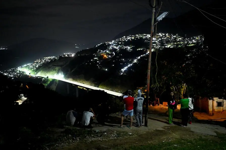 Residents stand outside their homes in the Gramoven neighborhood, as U.S. President Donald Trump said on Saturday the U.S. has struck Venezuela and captured its President Nicolas Maduro, in Caracas, Venezuela January 3, 2026. REUTERS/Maxwell Briceno , REUTERS