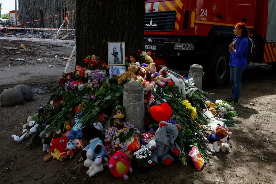 A makeshift memorial in Kyiv near the site of the Russian attack that destroyed a residential building leaving 24 people dead.