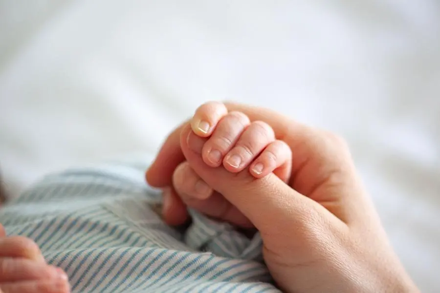 Baby Boy Holding Mothers Hand , Getty Images