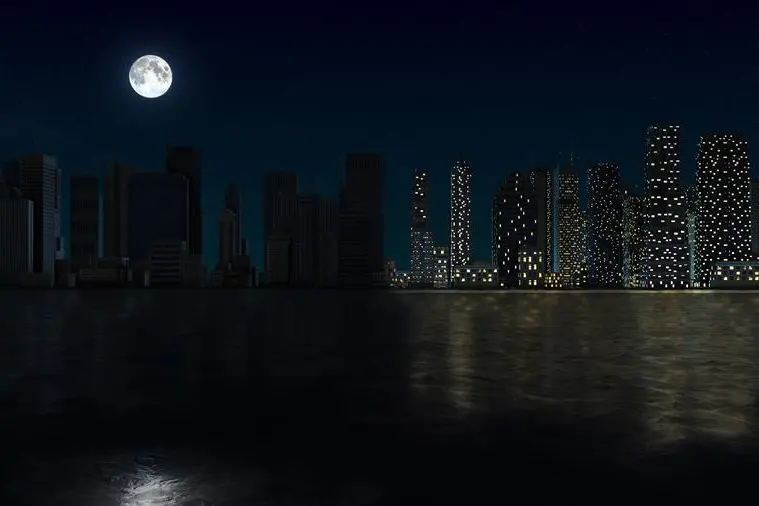 A city skyline fades into darkness during a widespread blackout, highlighting the sudden loss of electricity. High-rise buildings and neighborhoods are left in stillness as a power cut disrupts daily life. The scene captures the urgency and quiet tension of an unexpected urban emergency at night.