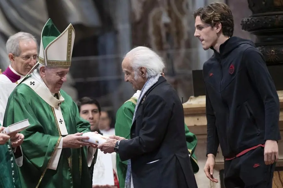 Antonino Zichichi receives the Bible from the hands of Pope Francis during the celebration in St. Peter's Basilica on January 26, 2020