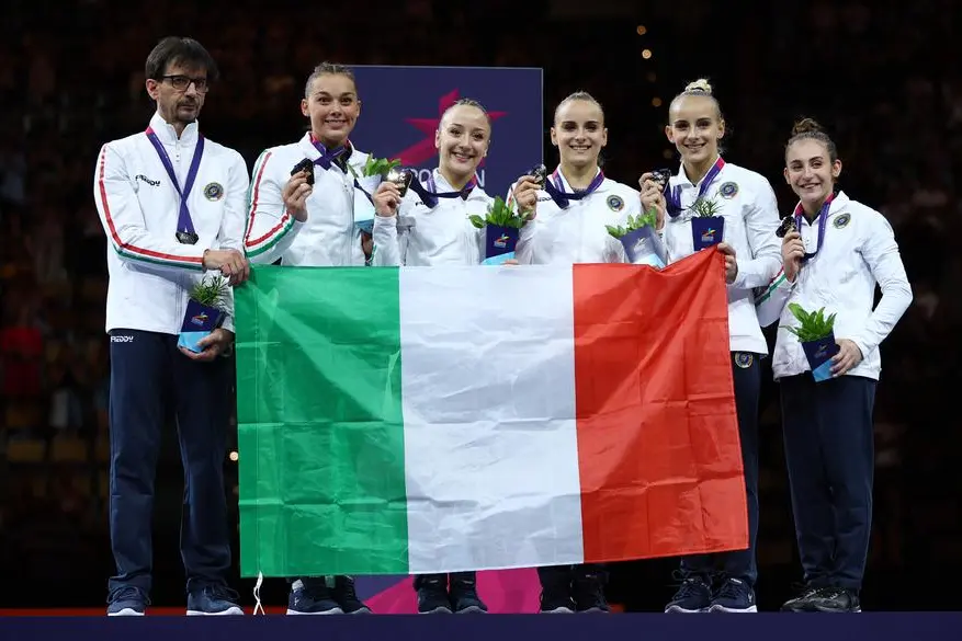 2022 European Championships - Artistic Gymnastics - Olympiahalle, Munich, Germany - August 13, 2022 Gold medallists Italy's Georgia Villa, Asia D'Amato, Angela Andreoli, Martina Maggio and Alice D'Amato celebrate on the podium after winning the women's team final REUTERS/Kai Pfaffenbach