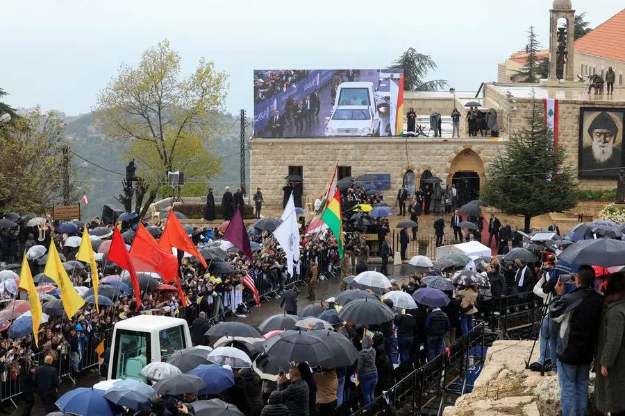 People watch Pope Leo XIV arriving to visit the tomb of Saint Charbel Makhlouf at the Monastery of Saint Maron, during his first apostolic journey, in Annaya, Lebanon December 1, 2025. REUTERS/Mohamed Azakir