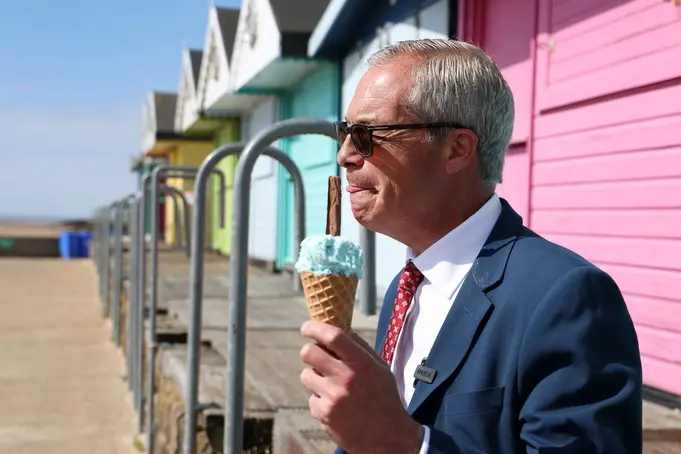epa12938398 Reform UK leader Nigel Farage eats an ice-cream after voting in local elections in Clacton-on-Sea, Britain, 07 May 2026. Millions of Britons are voting across the country in local elections on 07 May. EPA/ANDY RAIN