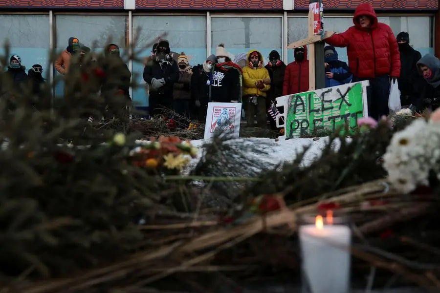 Flowers and candles on the site where Alex Pretti was killed by federal agents trying to arrest him, in Minneapolis, last Saturday