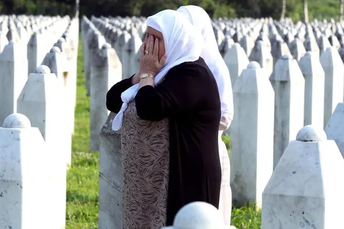 epa10739022 A Bosnian Muslim woman reacts during a funeral ceremony for thirty newly-identified Bosnian Muslim victims, at the Potocari Memorial Center and Cemetery, in Srebrenica, Bosnia and Herzegovina, 11 July 2023. The burial was part of a memorial ceremony to mark the 28th anniversary of the Srebrenica genocide, considered the worst atrocity of Bosnia's 1992-95 war. More than 8,000 Muslim men and boys were executed in the 1995 killing spree after Bosnian Serb forces overran the town. EPA/FEHIM DEMIR