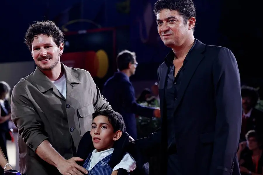 Il regista Tommaso Landucci, Andrea Aggio e Riccardo Scamarcio sul red carpet della mostra del cinema di Venezia per presentare I figli della scimmia , ANSA