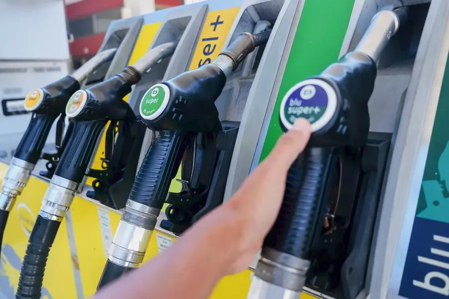 Mühlbach,Italy, August 18, 2019 - Close up shot of Asian customer holding a diesel fuel pump handle at gas station to refuel her vehicle, during Coronavirus pandemic