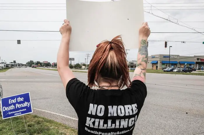 epa08548605 Protestors against the death penalty hold signs near the Federal Correctional Complex where the federal execution chamber is located in Terre Haute, Indiana, USA, 15 July 2020. As holds placed by federal judges work their way through the legal system, Wesley Ira Purkey waits to be put to death by lethal injection for the rape and murder of a 16 year old girl in 1998. Two more executions are scheduled for 17 July and 28 August as the US Justice Department resumed executions after more than 17 years with the execution of Daniel Lewis Lee on 14 July. EPA/TANNEN MAURY
