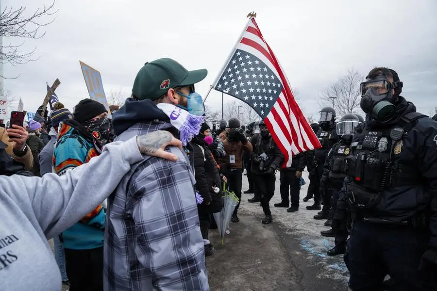 Minneapolis Police Department officers clash with protesters during an anti-ICE protest.