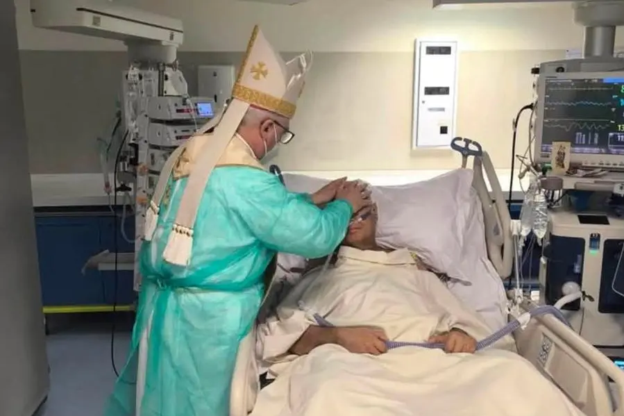 Un momento della celebrazione in ospedale con l\\'arcivescovo di Catania Luigi Renna che impone le mani a Pino Cannav\\u00F2