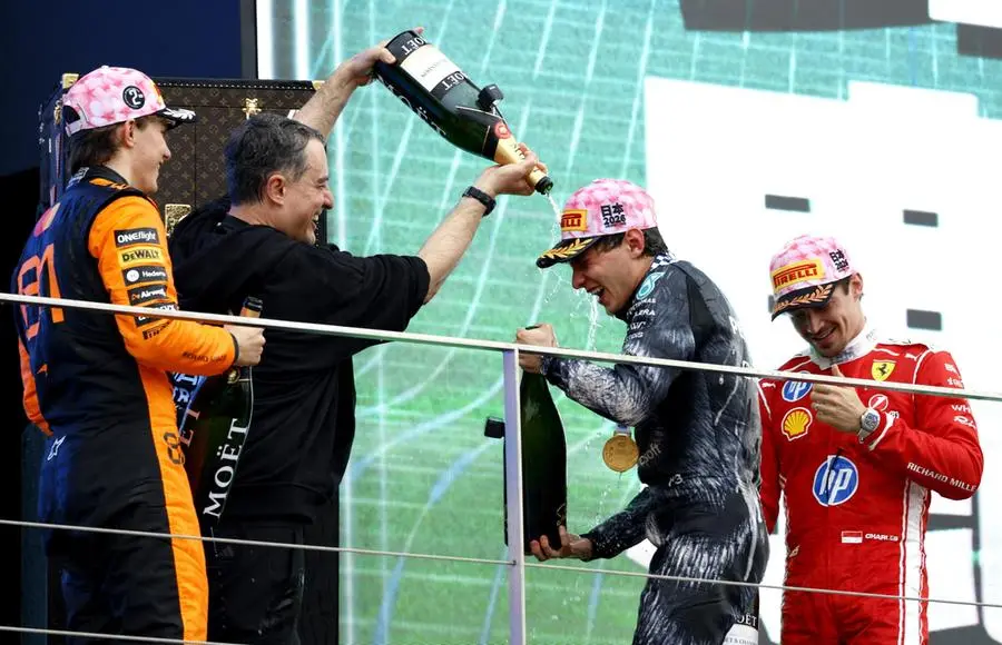 epa12858248 (from L) Second placed McLaren driver Oscar Piastri of Australia, winner Mercedes driver Andrea Kimi Antonelli of Italy and third placed Scuderia Ferrari driver Charles Leclerc of Monaco celebrate on the podium after the Formula 1 Japanese Grand Prix at the Suzuka International Racing Course racetrack in Suzuka, Japan, 29 March 2026. (person 2nd L is a Mercedes team staff member) EPA/FRANCK ROBICHON