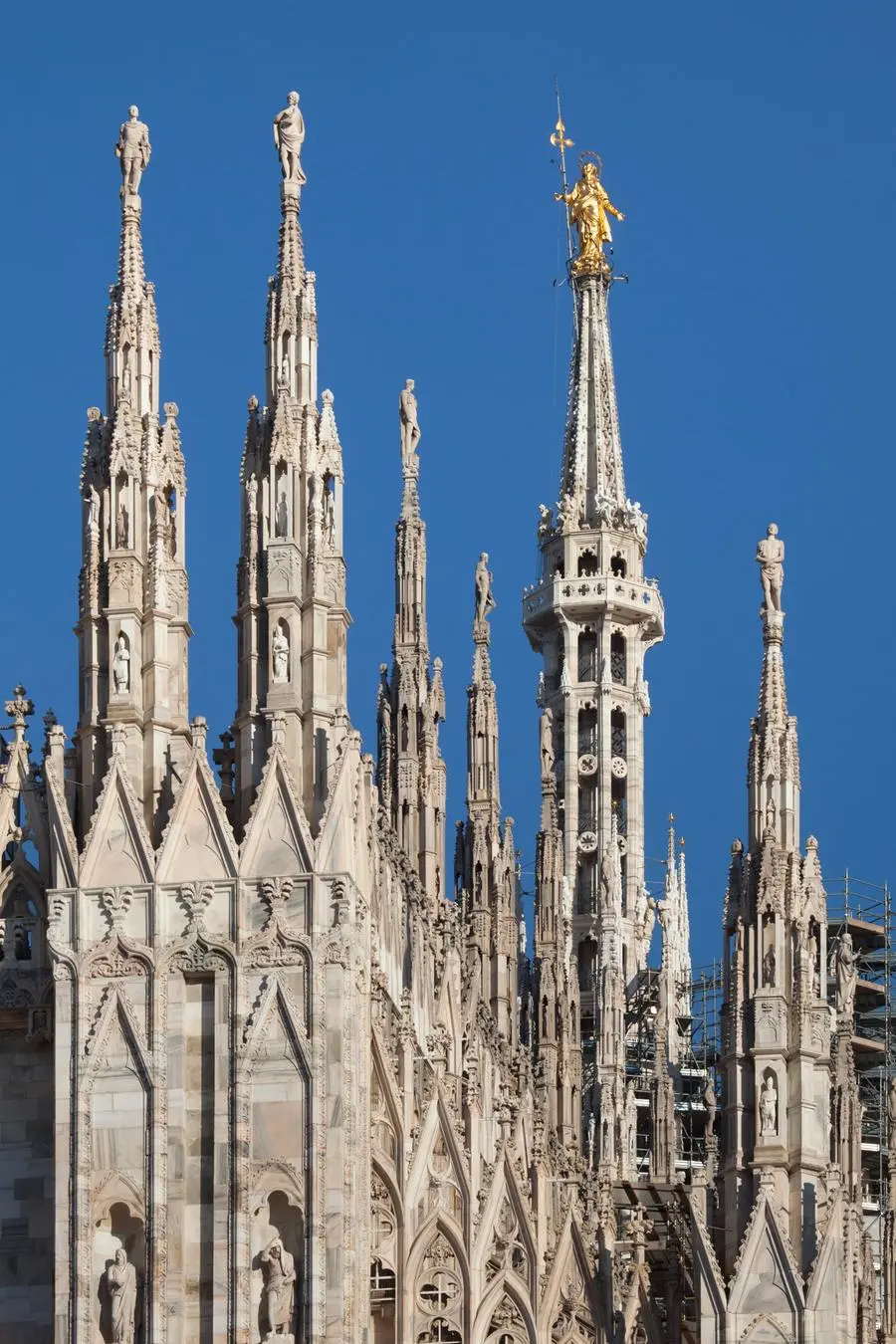 Gilded bronze statue of the Virgin Mary called the Madonnina on the spire of the Milan Cathedral in Milan, Lombardy, Italy.