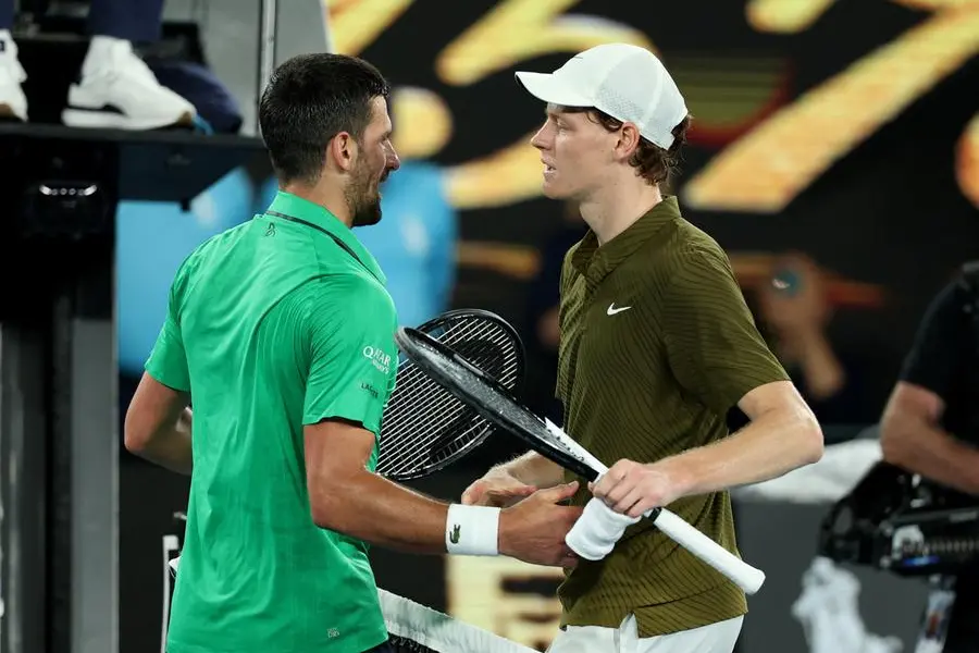 Tennis - Australian Open - Melbourne Park, Melbourne, Australia - January 31, 2026 Serbia's Novak Djokovic with Italy's Jannik Sinner after winning his semi final match REUTERS/Edgar Su