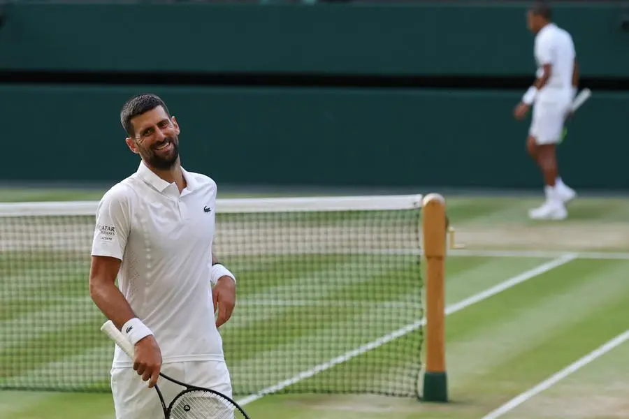 Jul 7, 2026; London, United Kingdom; Novak Djokovic (SRB) /smiles after losing a point against Felix Auger-Aliassime (CAN) /(R) on day nine of The Championships Wimbledon 2026 at All England Lawn Tennis and Croquet Club. Mandatory Credit: Geoff Burke-Imagn Images