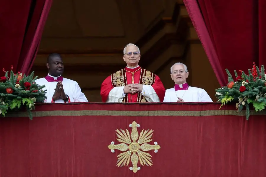 Pope Leo XIV stands on the main balcony of St. Peter\\'s Basilica to deliver the traditional Christmas Day Urbi et Orbi speech to the city and the world, at the Vatican, December 25, 2025. REUTERS/Yara Nardi , REUTERS